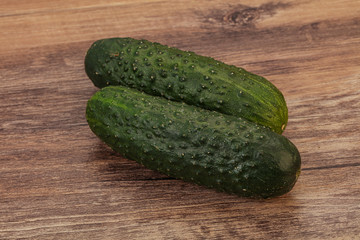 Green fresh cucumbers over background