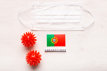 Coronavirus 2019-nCoV concept. Top view protective breathing mask and flag of Portugal. Novel Chinese Coronavirus outbreak.