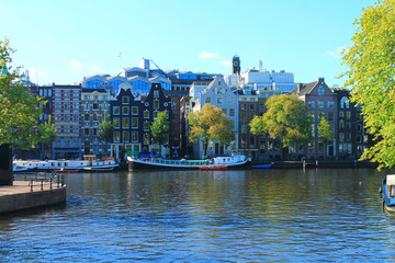 Naklejka premium View of the canal and the streets of Amsterdam in summer