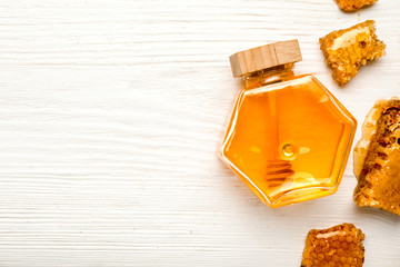 Jar of sweet honey on white wooden background