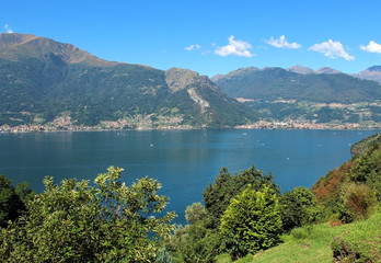 Fototapeta na wymiar Lake and mountains covered by vegetation landscape in summer - Lake Como in Italy