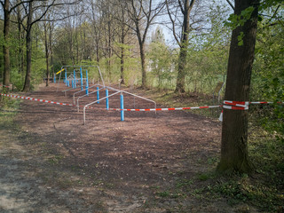 Obraz na płótnie Canvas Outdoor workout trainings grounds blocked with barrier tape during Corona pandemic lockdown on Easter Monday 2020 in Regensburg, Bavaria, Germany