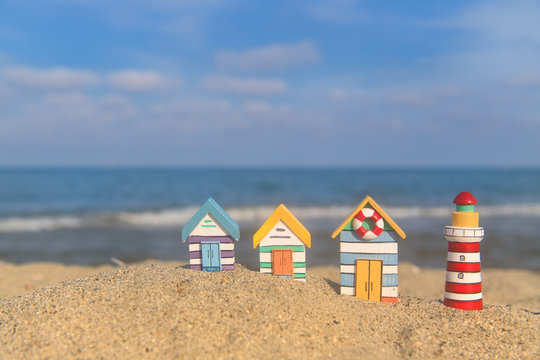 Miniature huts and lighthouse at beach