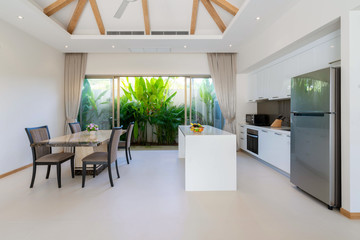 Interior design of open space dining room and kitchen in pool villa, house, home, condo and apartment feature kitchenette