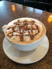 Christmas hot choloate with whip cream and sprinkles.