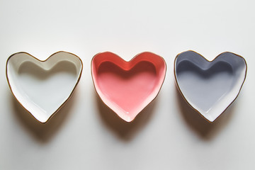 Three plates of hearts on a white background in blue, red and white.