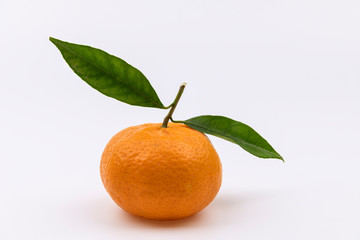 One whole clementine with green leaves isolated on white background
