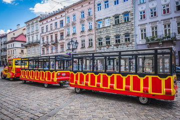 Naklejka na ściany i meble Tram for tourists on a main square of Lviv Old Town, Ukraine