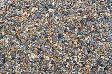 Small crushed multicolored road stones of different shapes and sizes. Gravel texture and natural background for design