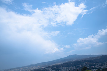 Fototapeta na wymiar clear blue sky with clouds with mountains
