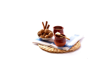 Natural goat milk curd with cinnamon, walnuts and honey in clay glass and wooden spoon