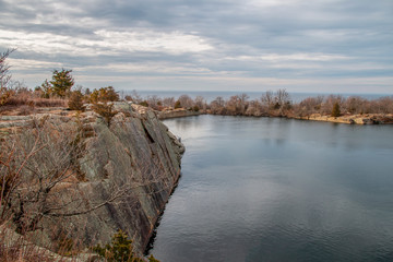 Calm water over a rocky quarry