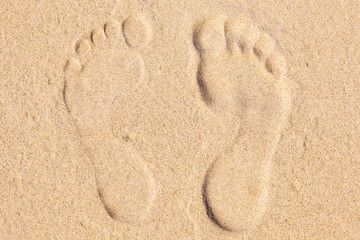 Fototapeta na wymiar Two Footprints in sand at the Beach