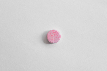 pink pill on white background. drugs isolated white copy space. healthcare medicine concept, aspirin, antibiotics