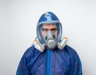 a man in a protective blue suit and a protective mask close up