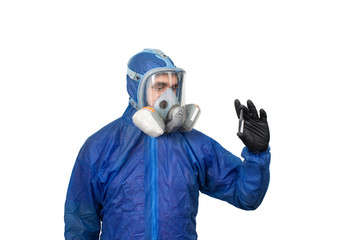 a man in a protective blue suit and mask holds medicine