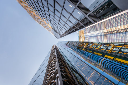 Looking up a reflections on glass covered corporate building