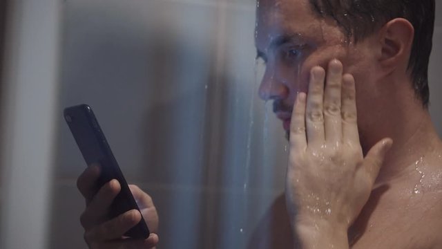 internet addiction disorder man is in shower with smartphone