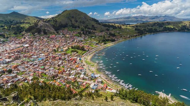 Copacabana, Bolivia, zoom out time lapse view of waterfront and Lake Titicaca on a sunny day.
