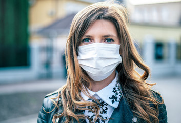 Virus mask. COVID-19. Woman walking in public space wearing face protection in prevention for coronavirus.