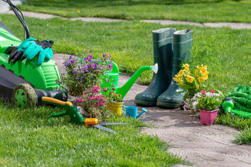 Set Of Tools For Gardener And Flowerpots In Sunny Garden © Smole