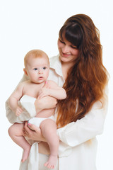 young brunette mom with long hair and a white shirt holds a newborn son. A 4 month old baby in her arms. Isolate