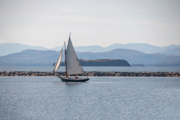 Fototapeta premium Sailboat floating over a glistening lake