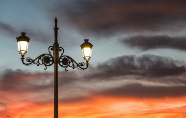 Ornate antique streetlight lantern at dusk