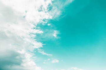 White clouds on mint aqua menthe color sky background