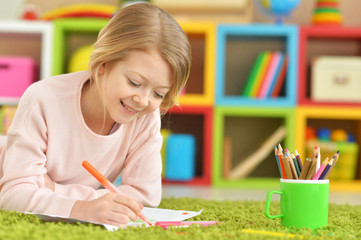 Close up portrait of cute smiling girl drawing