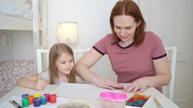 mom and daughter drawing rainbow. stay at home.