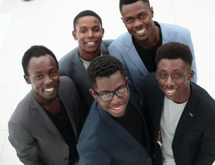 top view .smiling young business people looking at the camera