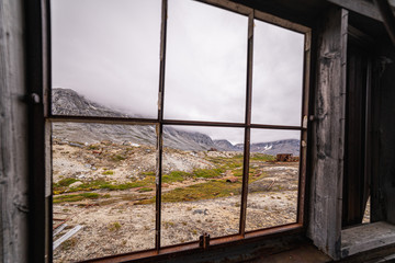 Fototapeta na wymiar Looking at the mountains from the remnants of an abandoned military base. Greenland. 