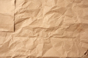 Obraz premium crumpled blank sheet of brown wrapping kraft paper, vintage texture for the designer