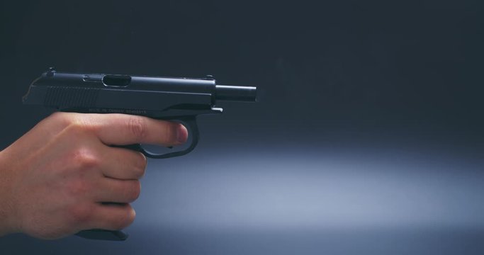 man hand shoots with a air gun on black background the gun ran out of ammunition