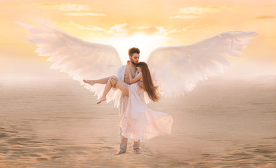 Fototapety  Strong male costume angel holds hug fragile innocent woman in arms. concept protection prayer security helper keeper love faith help religion. art sunset sky in desert. Girl and handsome man embracing
