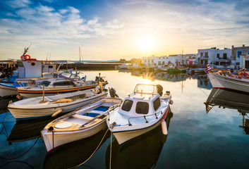 Fototapeta na wymiar Fishing boats in port of Naousa on sunrise. Paros lsland, Greece