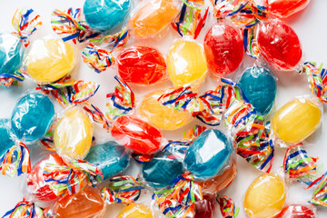 Mix of hard wrapped candies isolated on white background.