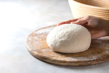 Homemade bread. Woman hands kneading fresh dough for making bread.