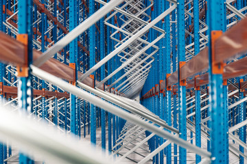 Fototapeta premium Empty shelves in distribution warehouse. Close up shot of metal construction