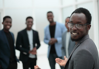 project Manager standing in front of applauding working group.