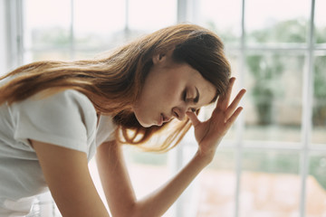 young woman looking through window