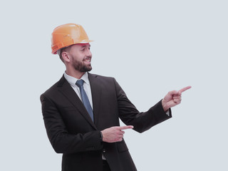 in full growth. serious businesswoman in helmet pointing somewhere to the side