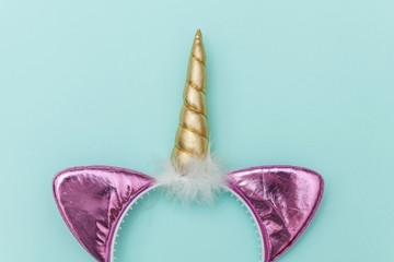 Halloween party accessory unicorn horn hairband isolated on blue pastel colorful background