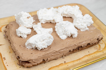 White whipped cream on the chocolate cake