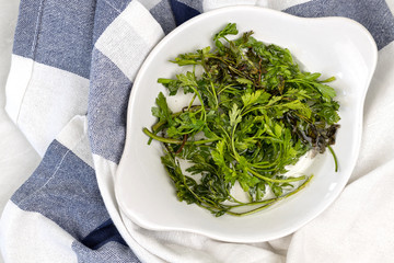 Parsley leafs in the water in the bowl