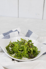 Parsley leafs in the water in the bowl