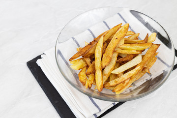 French fries served in the bowl on the table