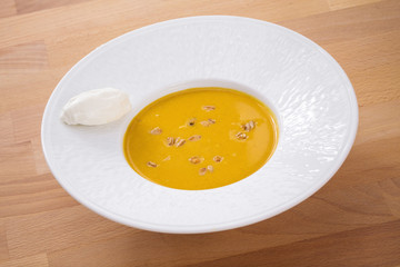 Delicious homemade pumpkin soup with seeds and goat cheese. Perfect for appetizer. Organic Arabic dish perfect for vegan. Healthy food photography.