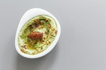 Organic plant based hummus with granola and dates cream toppings. Perfect for vegan gluten free. Top view food photography